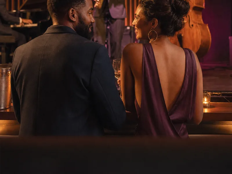 Fictional adult couple enjoying live music at a South African venue