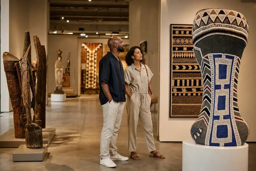 Adults exploring a South African cultural gallery